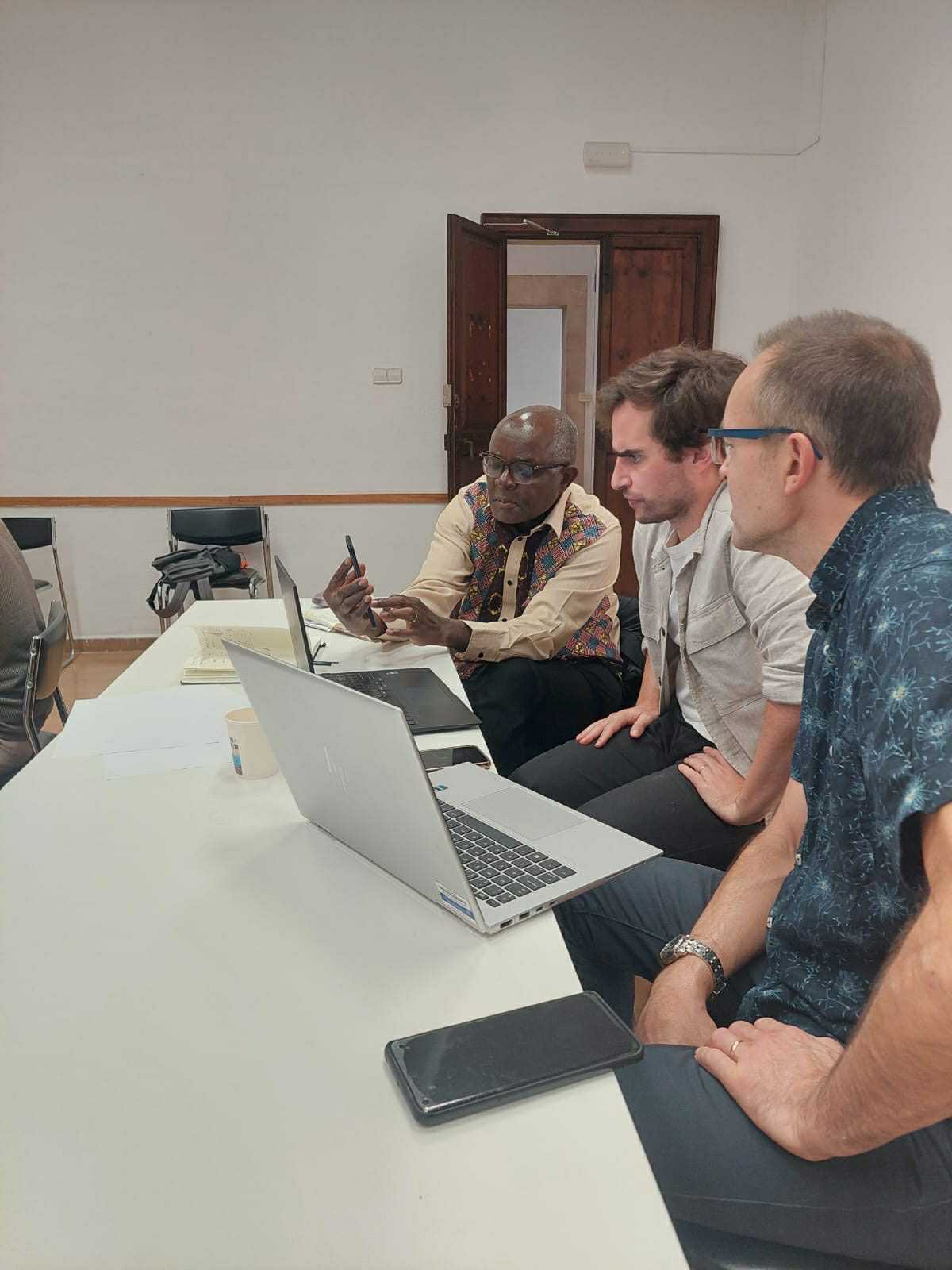 DiverSea team members discuss and look at laptops