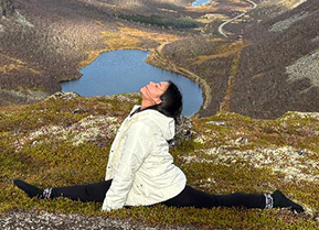 Student doing the splits in nature. Photo
