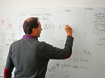 Lecturer writing on a whiteboard. Photo: NTNU/Lars R. Bang