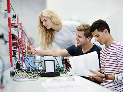 Three people working in the Smartgrid laboratory. Photo: Geir Mogen