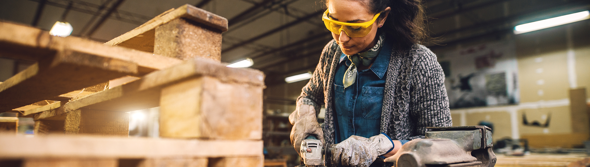 Women working with tools on a plank.Photo