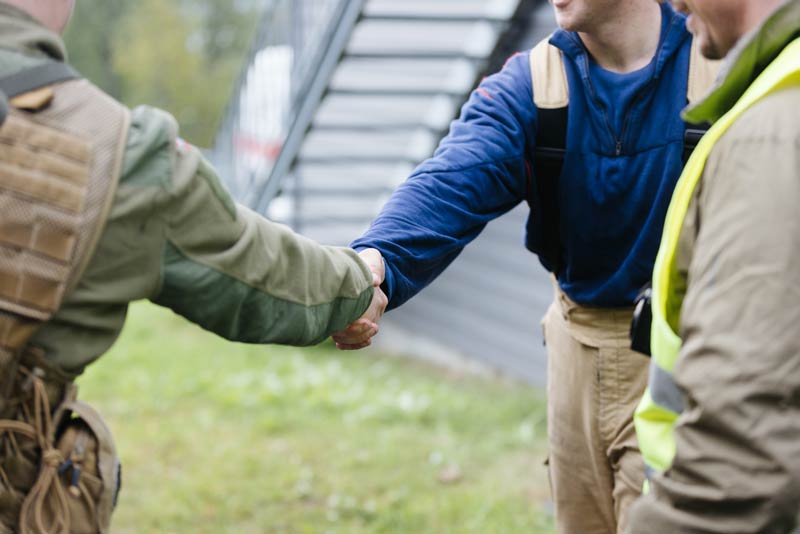 Two emergency personnel shaking hands