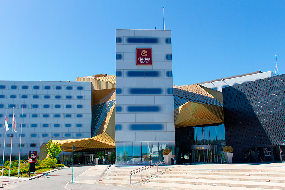 Photo: Clarion Hotel Trondheim Exterior, a modern facade in white and gold.
