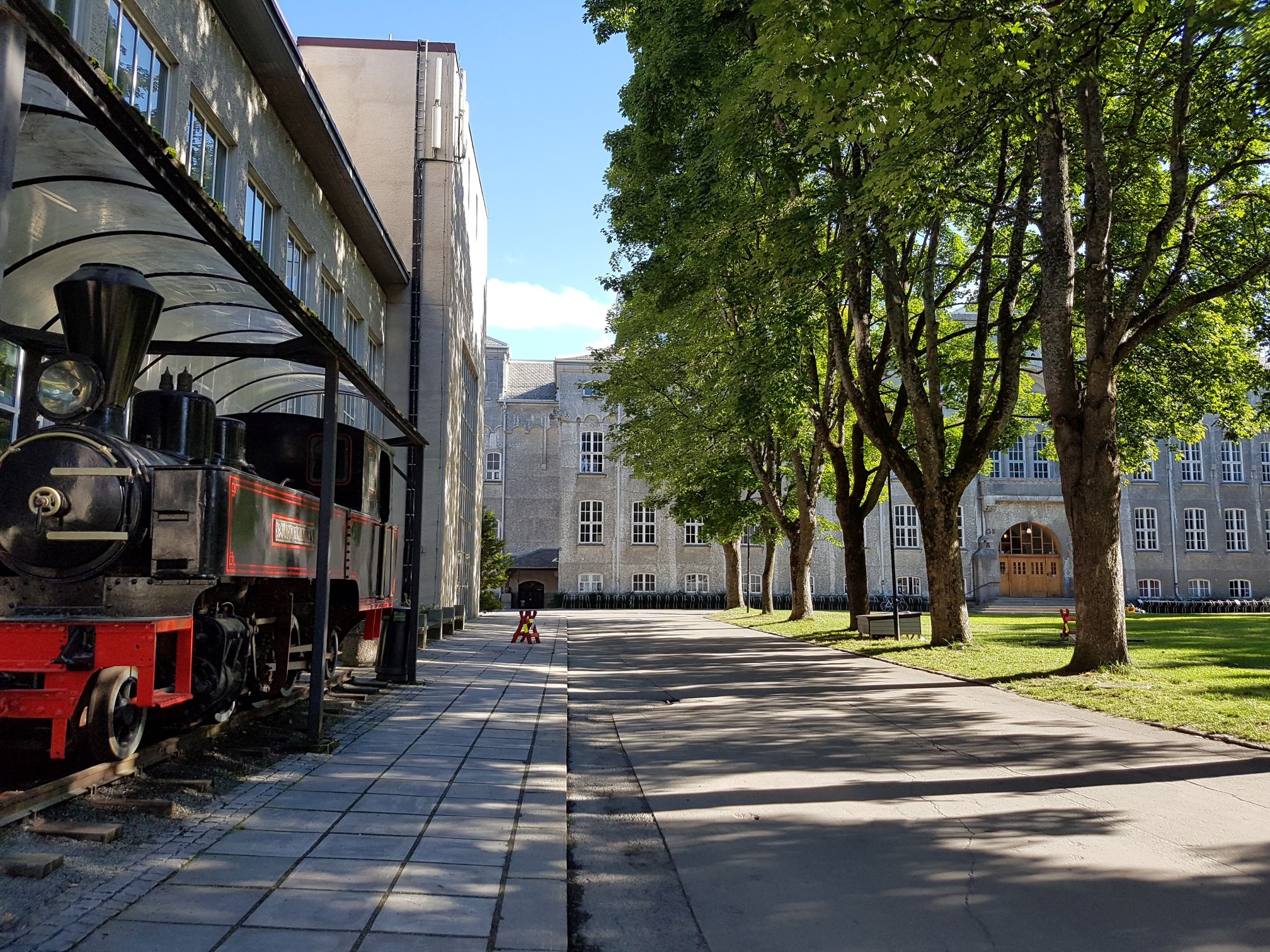 Grey buildings and a train