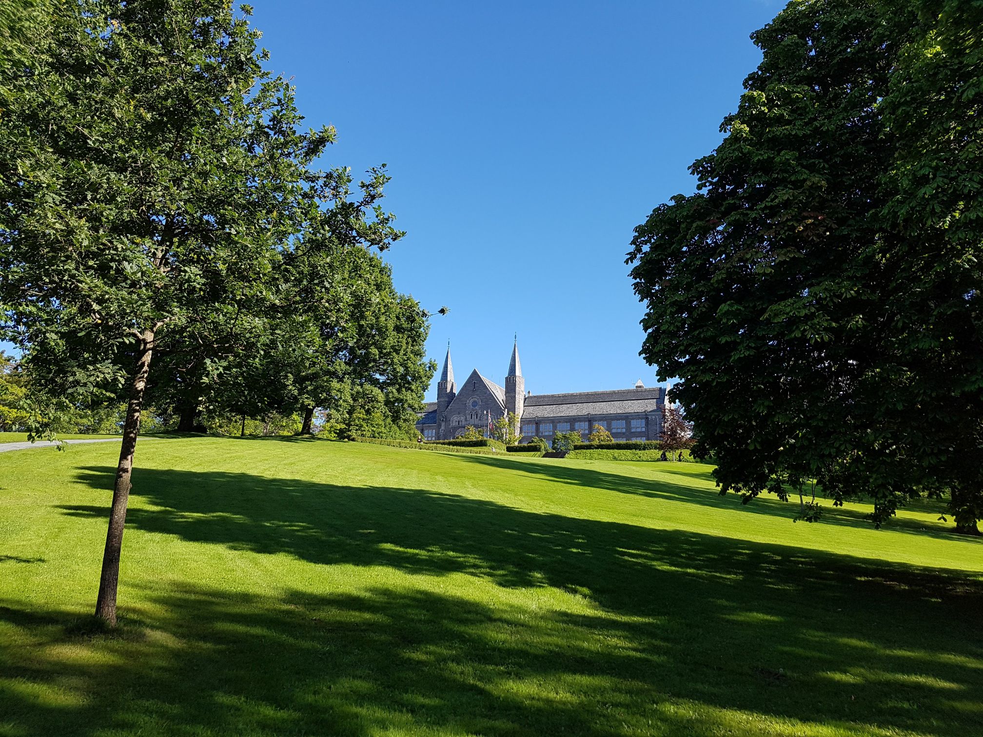 A park with a stone building