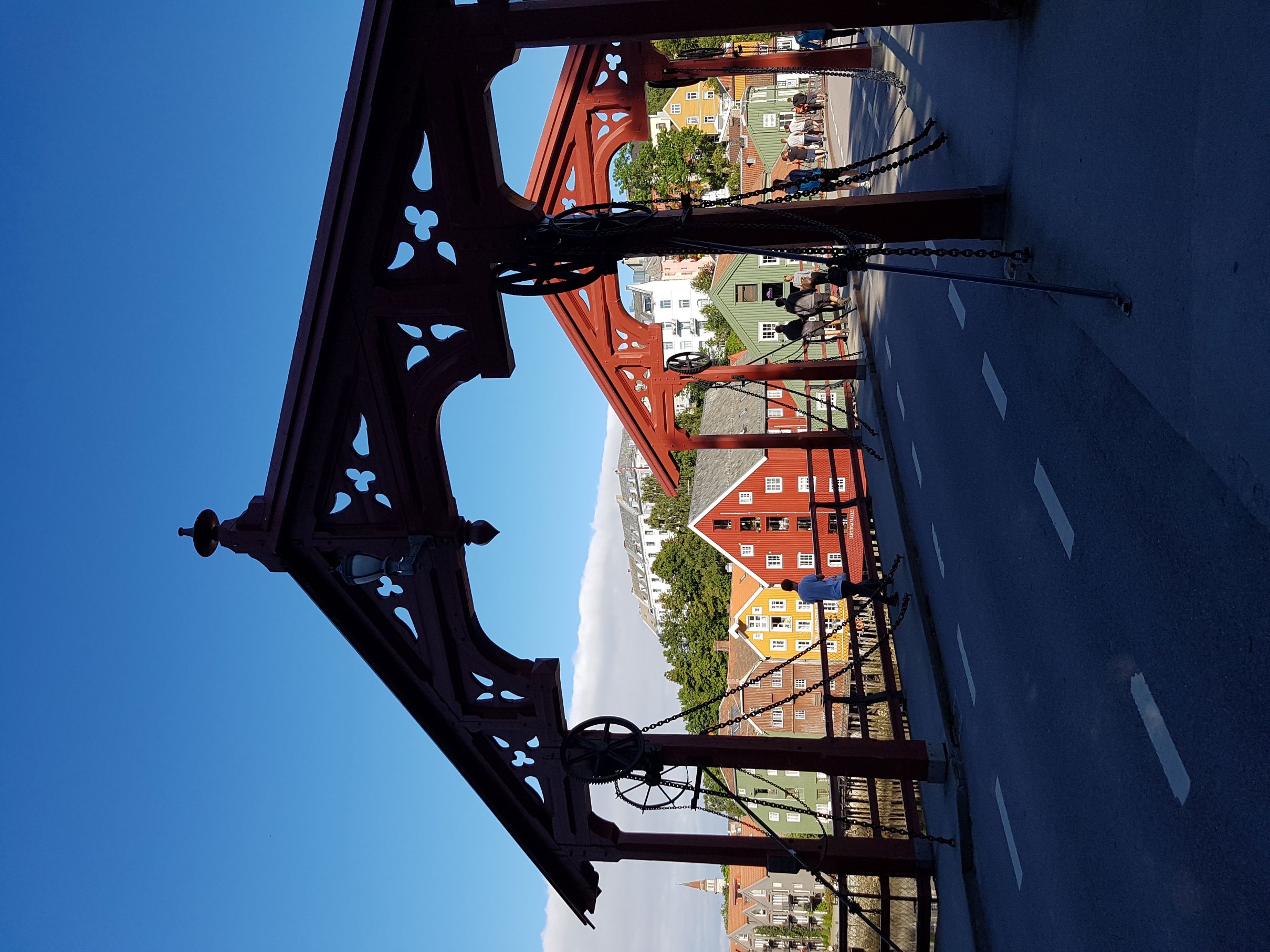 A bridge with wooden buildings in the background