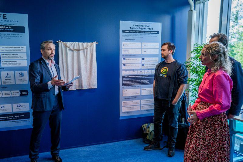 SAFE collaborators beside digital-fraud research posters at the inauguration