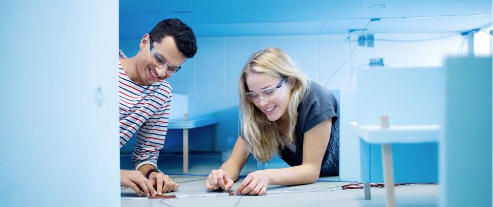 Two students testing batteries