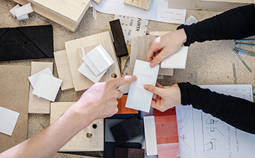 Hands holding material samples