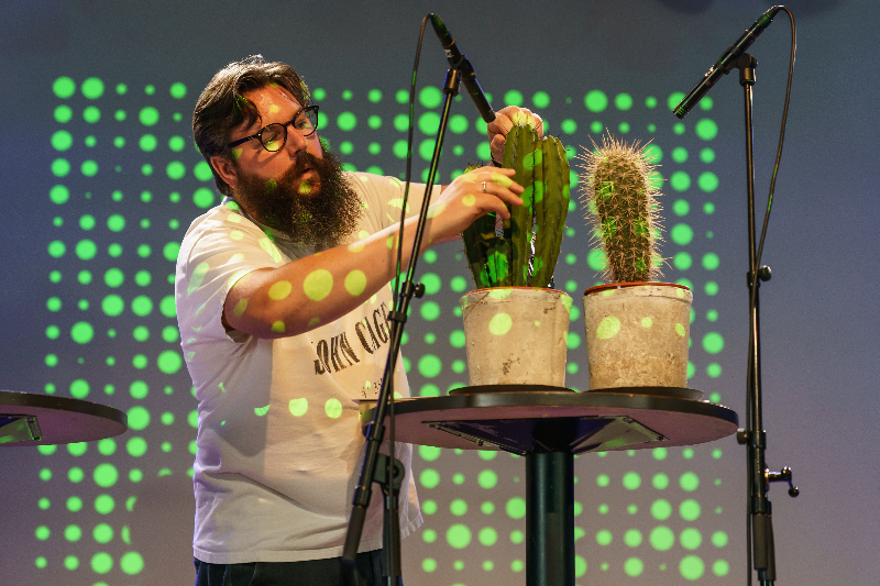 Michael Duch performs music on a cactus