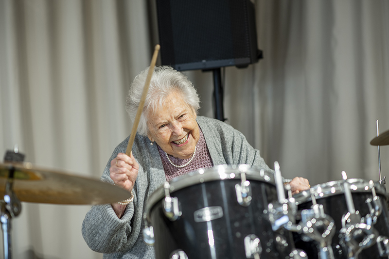 Elderly woman on drums