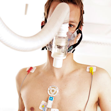 Close-up of a person with an oxygen mask and attached sensors