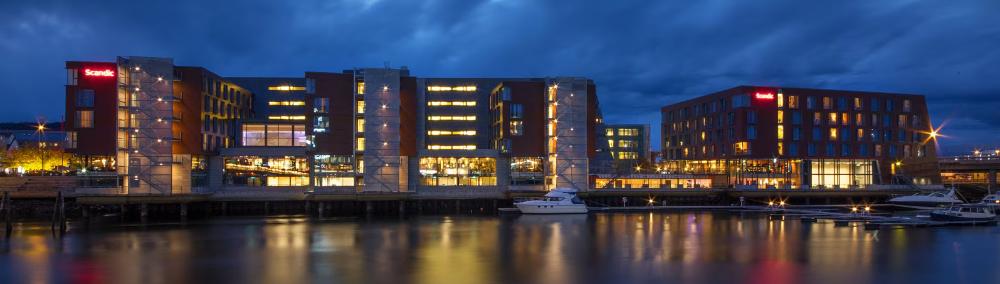 Waterside front of hotel at night time. 