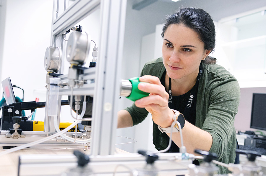 PhD Candidate regulating an instrument in a laboratory
