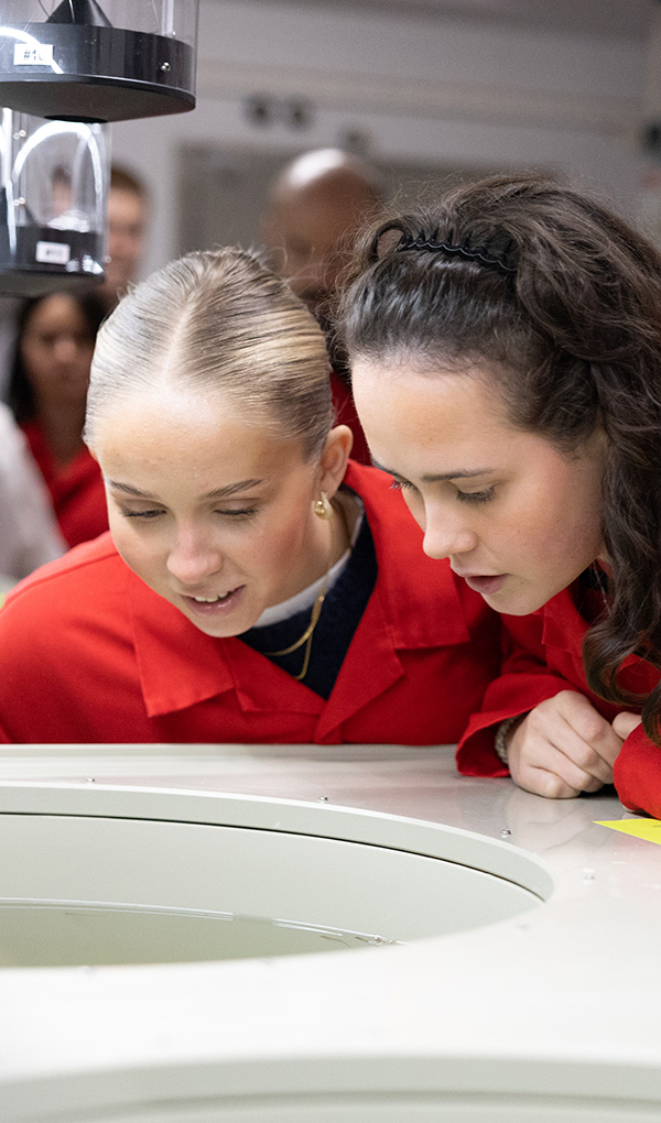 Two students looking into a big fish tank