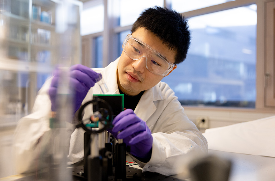 A man looking at a sample in a laboratory