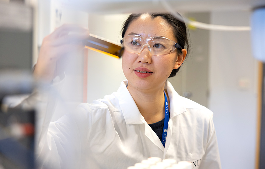 A woman looking on a sample in a laboratory
