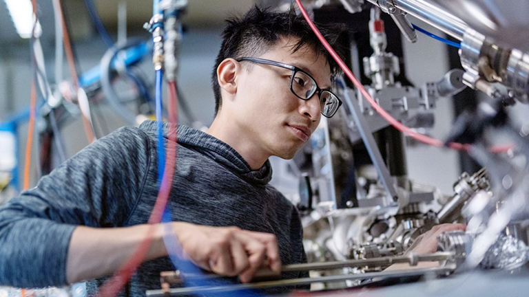 A man working with an instrument in a lab