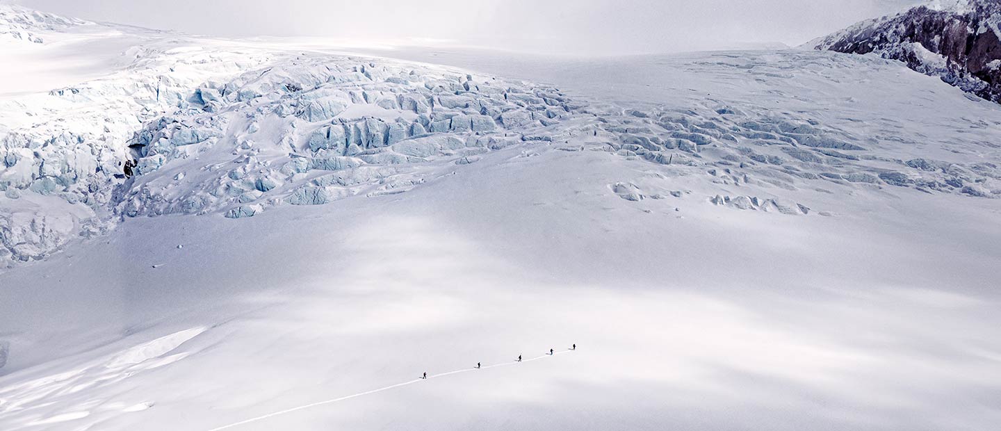 Photo of people on cross country skis in snowy mountains