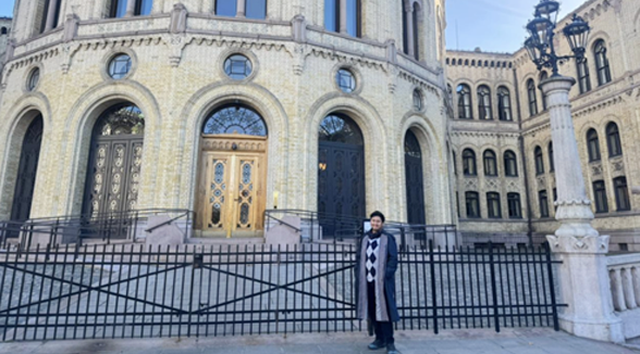 Fauzan in front of Stortinget in Oslo
