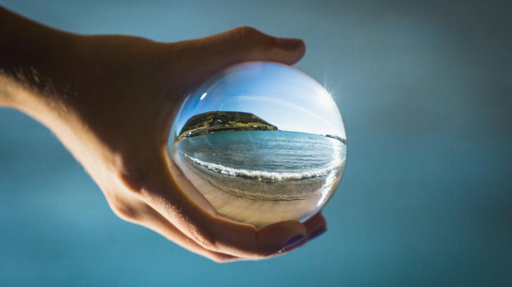 Hand holding glass globe. Photo