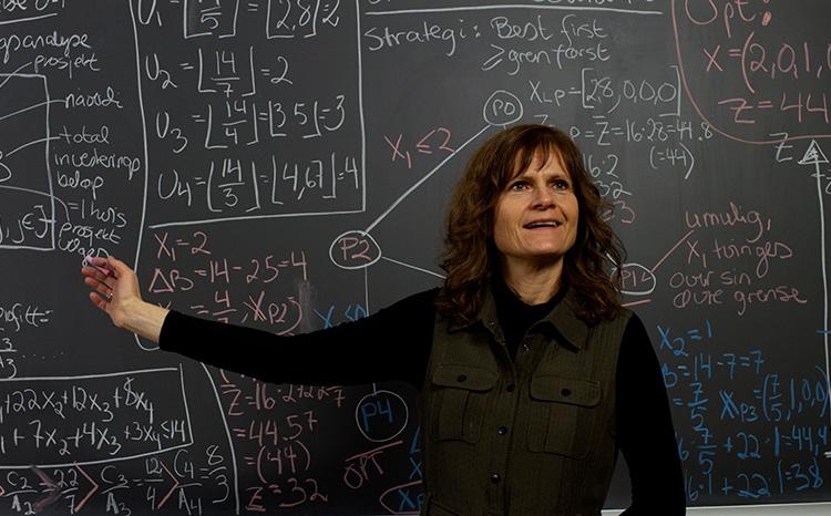 Professor in front of blackboard. Photo. 