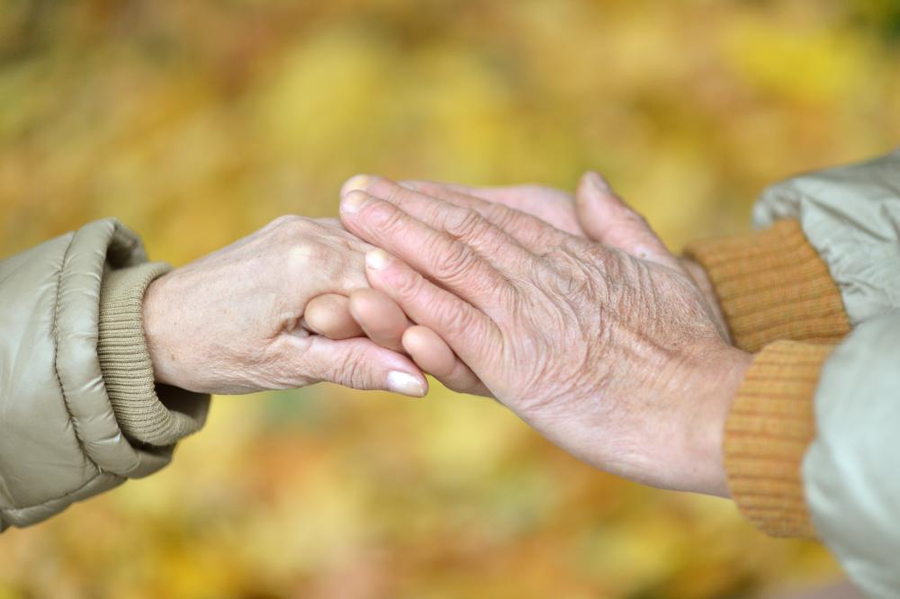 Elderly couple holding hands. Picture.
