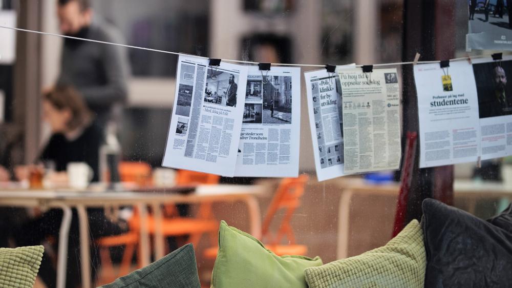 Newspapers hanging on a line. Photo.