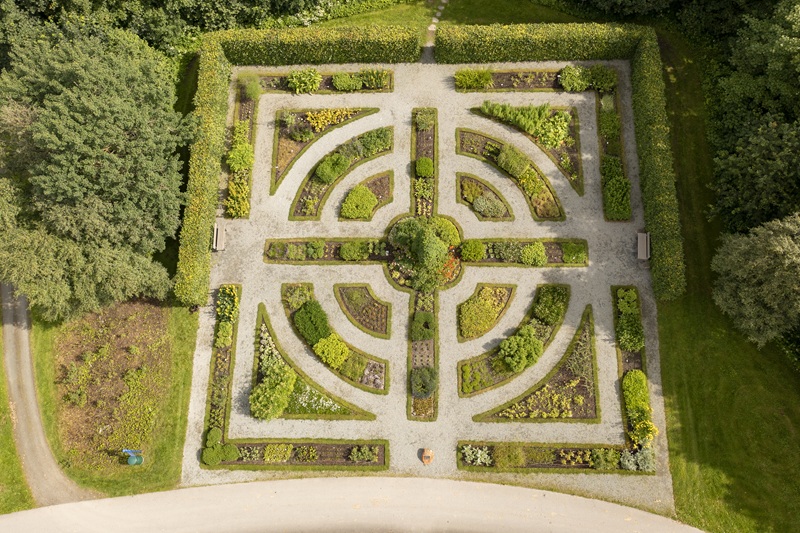 Aerial drone photograph of the Renaissance garden, with its distinctive geometric flower beds forming square and circular designs.