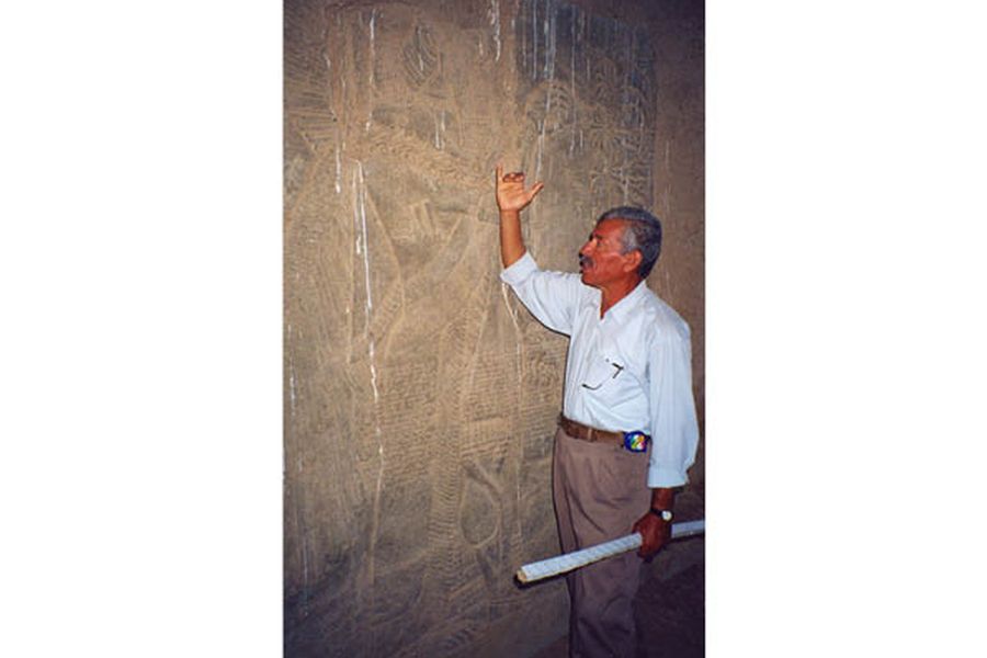Photo: an Iraqi archaeologist shows reliefs from Nimroud, autumn 2002.