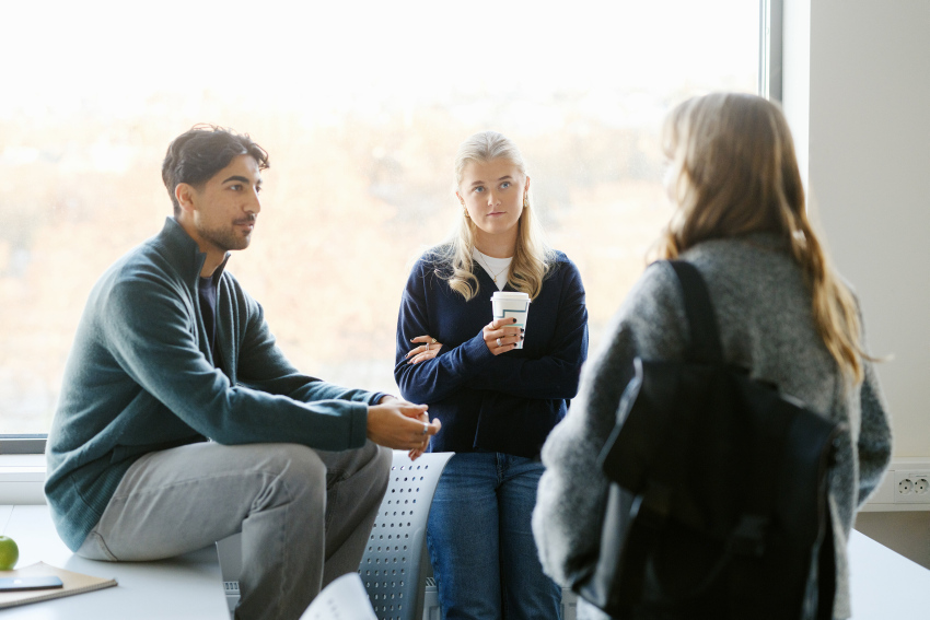 Three students having an enthusiastic discussion during their study break