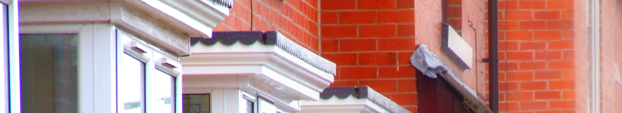 Cropped photo of a house wall and parts of a window. Illustration photo.