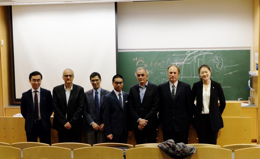Professors and students standing in front of a blackboard. Photo