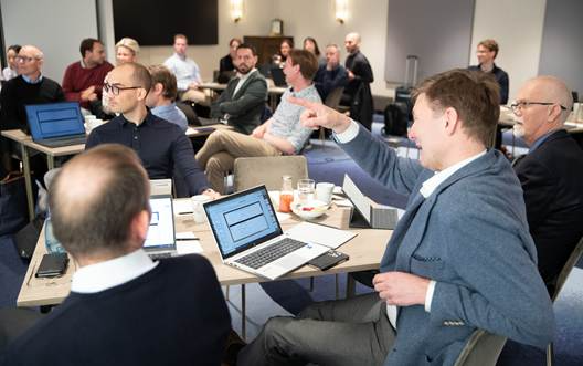 Workshop Room shows participants seated around tables with laptops for th PIMS Executive Forum in May 2023 